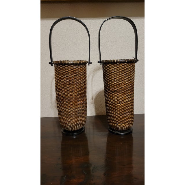 Beautiful decorative pair of weaved tall baskets with round wooden base and screw on wooden handle.
