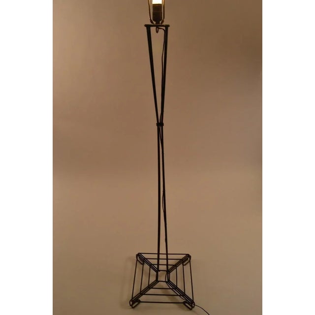 Interesting waisted form floor lamp constructed of bent iron rods. Black paint finish over iron rod frame, working,...