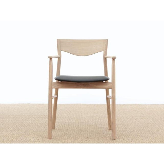 Magrethe armchair in oak. Black leather seat. Dimensions h 81 cm. W 55 cm. D 50 cm. H seat 47 cm. H arms 66 cm material...