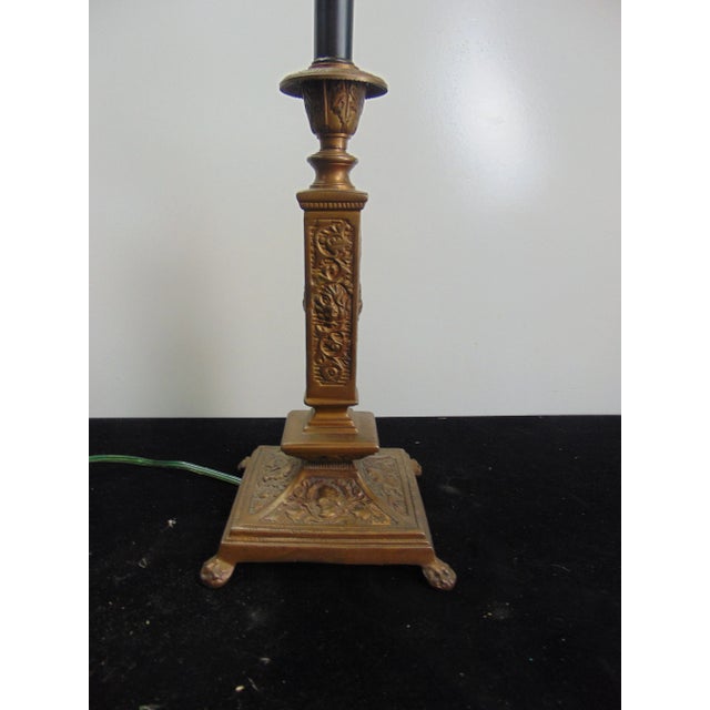 John Richards Candlestick form lamp , classical style , made of bronze, woman’s bust and other details , paw feet .