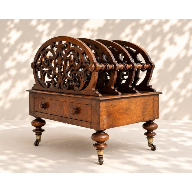 An elegant 19th-century Victorian English magazine rack, crafted entirely from wood and resting on four turned feet with...