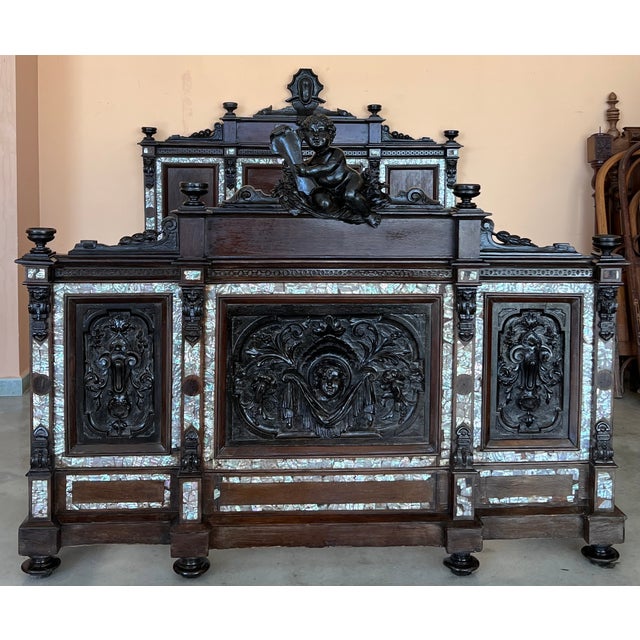 King-size bed with an impressive Renaissance-style headboard and footboard, crafted from beautiful walnut wood. The bed...