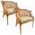 A striking pair of cane barrel back lounge chairs featuring beautifully woven cane panels and a natural wood finish that...