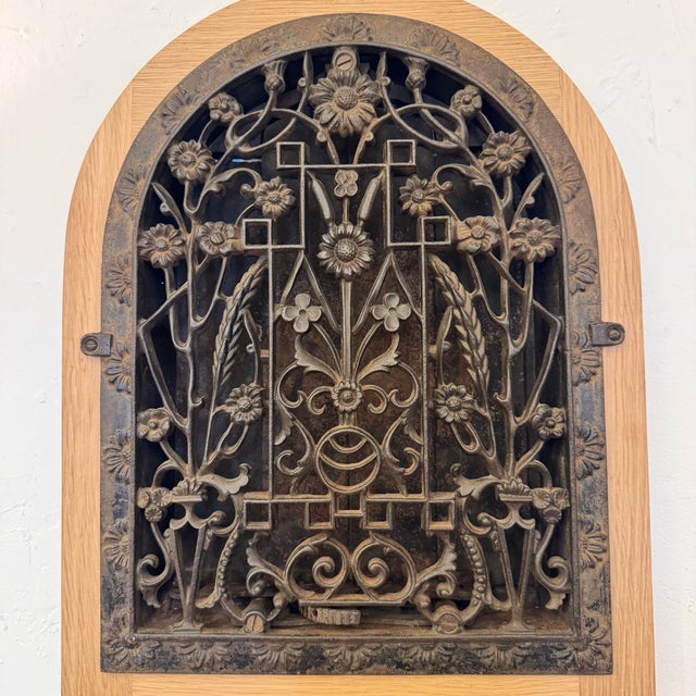 Heavy Cast Iron Antique Architectural Grille with a floral botanical motif surrounded by a custom wooden frame. Circa...
