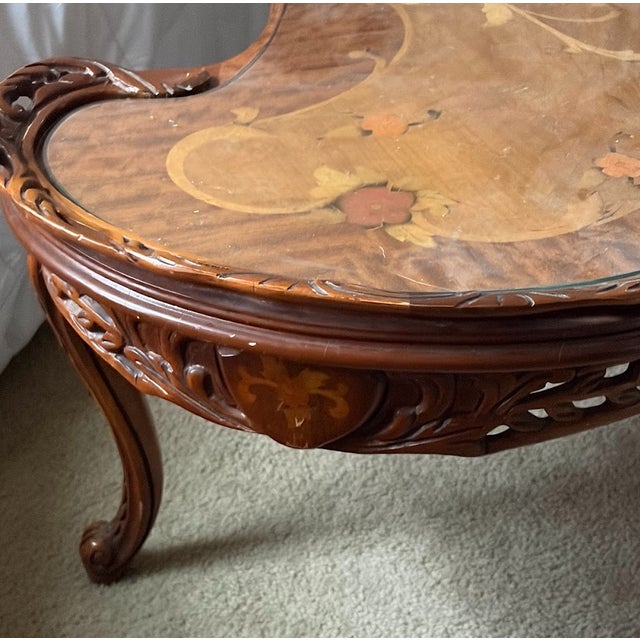 A stunning vintage French Provincial serpentine kidney‑shaped coffee table, crafted with exquisite marquetry inlay and a...