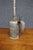 Antique industrial oil can constructed of tin with a cylindrical body, long tapered spout, side handle, and spring-...