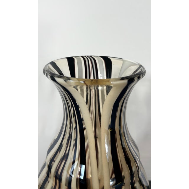 This commanding 17-inch hand-blown art glass vase features a sophisticated "Fenicio" or combed-thread technique....