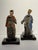 A charming pair of Chinese polychrome roof fragments depicting robed figures on modern wood stands. These figures would...