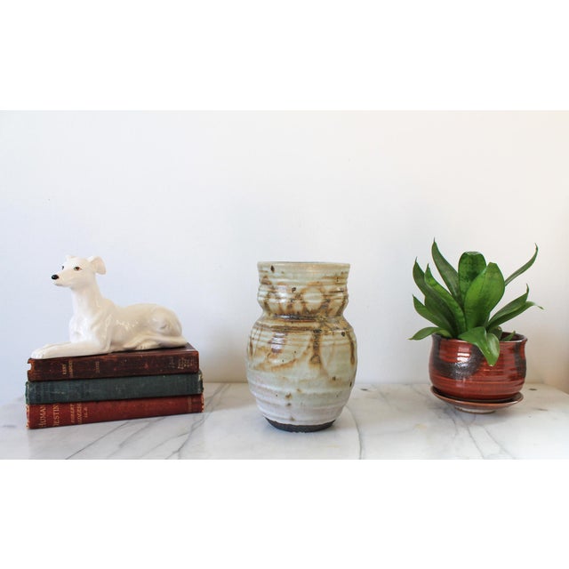 Vintage beige and brown studio art pottery vase. Signed by artist on bottom. Minor age wear. No chips or cracks.