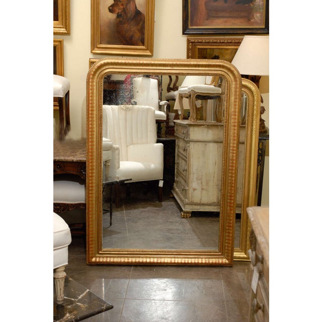 Large French gilt Louis Philippe style mirror with nice detail. Dimensions: Height: 56 in (142.24 cm) Width: 40.5 in...