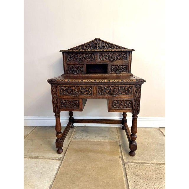 Fine quality antique Victorian carved oak writing desk, having a quality antique Victorian writing desk with a raised back...