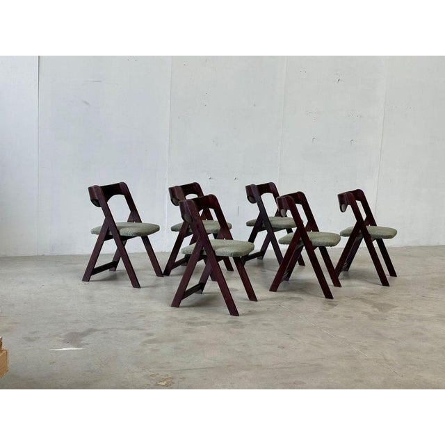 Mid century wooden dining chairs consisting of curvy wooden frames with olive green fabric seats. Beautiful timeless...