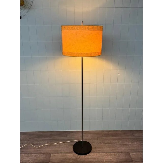 Vintage Italian floor lamp from the 1950s composed of a round cast iron base and nickel-plated brass stem Round lampshade...