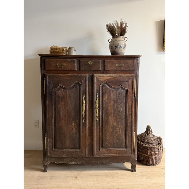A remarkable late 19th-century French oak cabinet distinguished by its taller, more architectural proportions and finely...
