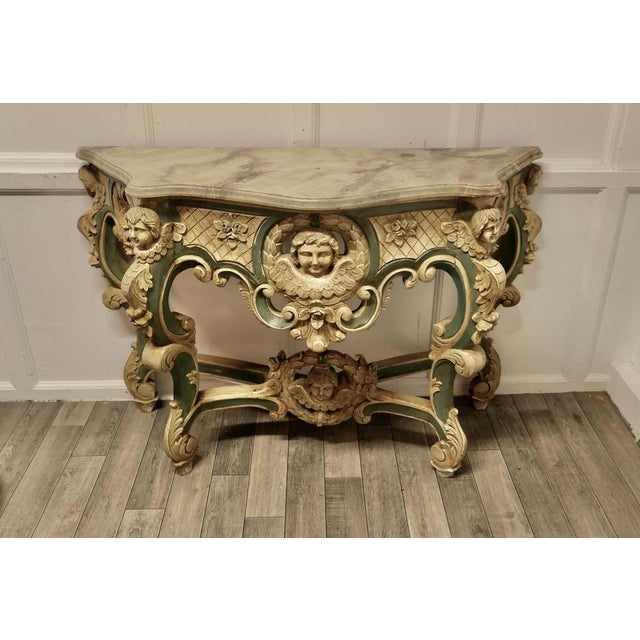 French Baroque Console Table, Carved and Painted with the Faces of Angels This is a very attractive piece, the table is...