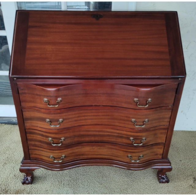Stunning high quality mahogany secretary desk with four serpentine drawers and ball and claw feet. Made by the Maddox...