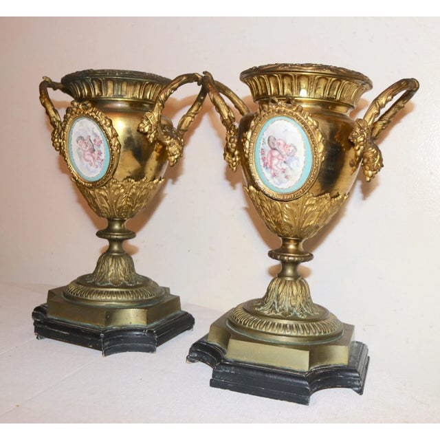 Up for sale is a very high quality pair of antique gilt bronze and painted porcelain garniture vases. They're made of...