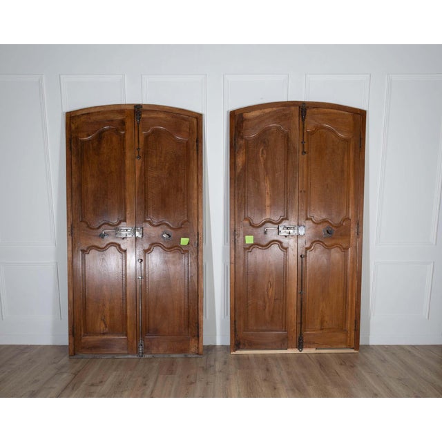 Two exceptional pairs of French communication doors, finely crafted in solid walnut and dating from the 18th century. Each...