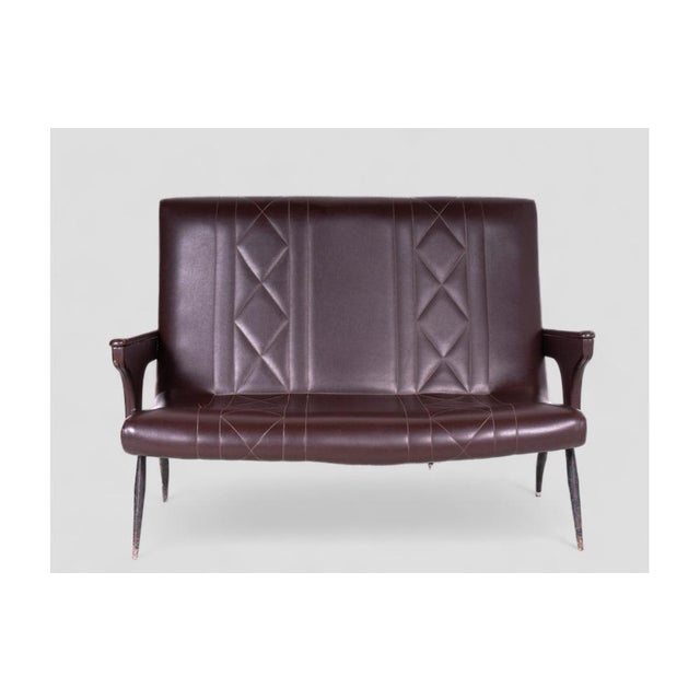 This elegant vintage two-seater sofa, upholstered in brown skai, is ideal for adding a retro touch to any space. The...