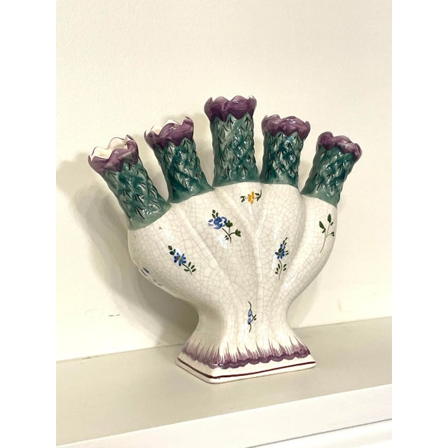 On thi five finger, (tulipiere) vase there is an embossed lattice feature embedded on each "finger" opening, as well as,...