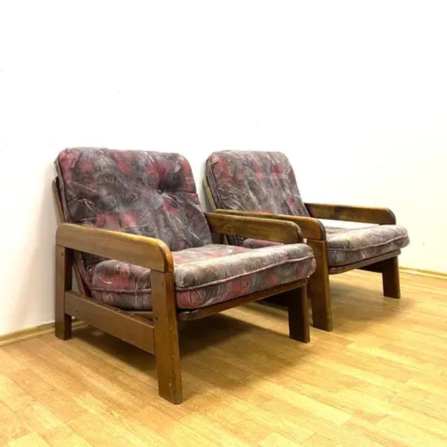 A pair of stylish retro armchairs from the second half of the 20th century, featuring a solid wooden frame, removable...