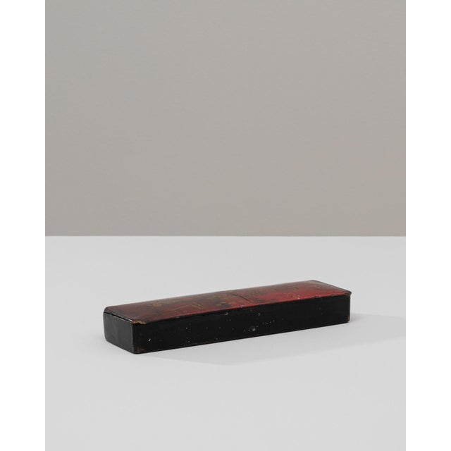 This 20th Century Asian wooden box features a refined rectangular form adorned with handcrafted gold details that subtly...