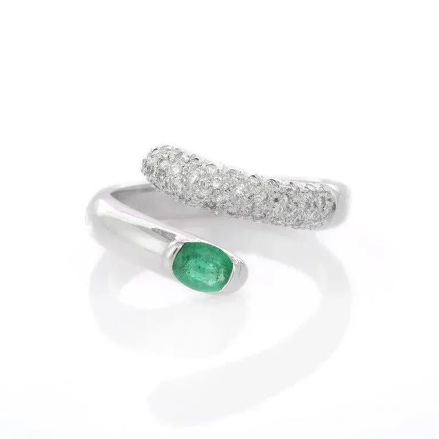 Oval Cut Emerald Diamond Cluster Bypass Ring in 18k White Gold For Sale
