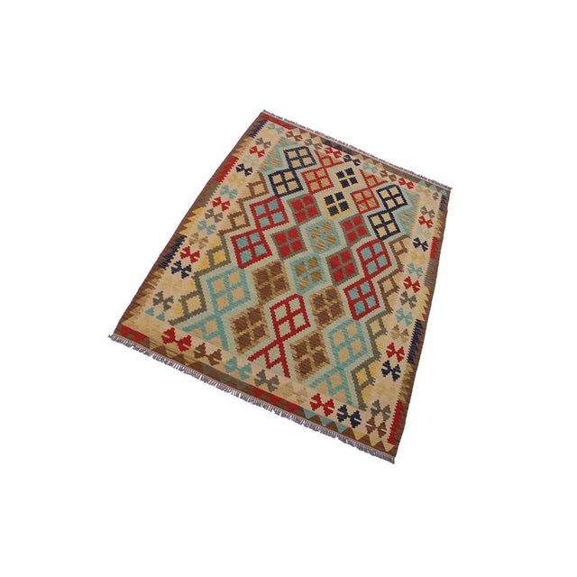 "Add a touch of elegance to your home with this casual chic hand woven Tribal Kilim wool rug. Constructed on a loom by...