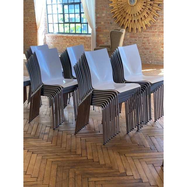 Stacking chair in green & white melamine and polished chrome steel frame. The bicolor chairs with high backrest are in...