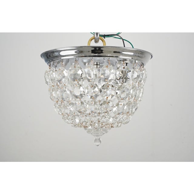 Traditional style flush mount light made of draped faceted crystals and a polished chrome steel frame. This requires one...