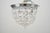 Traditional style flush mount light made of draped faceted crystals and a polished chrome steel frame. This requires one...