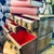Vintage Schmid Bros wooden musical jewelry chest featuring seven drawers with paneled fronts, metal drop pulls, and red...