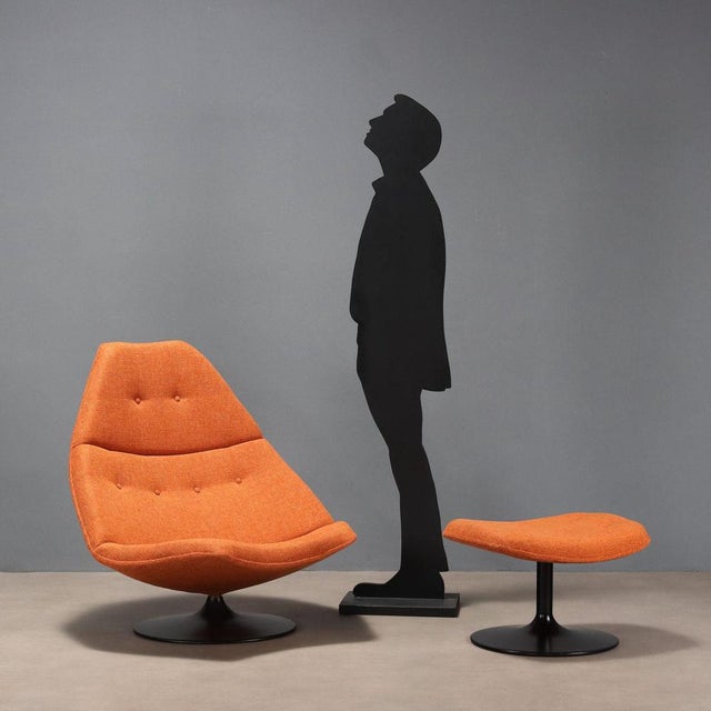 Space Age-style swivel armchair with footrest, recently renovated with orange fabric, foam padding and an enamelled metal...