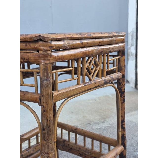 Set of three Art Nouveau stackable Italian bamboo tables. The medium one measures 63cm in height, 32cm in width, and 30cm...