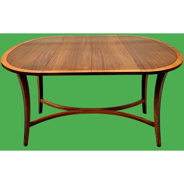 This Vintage Charak "Danbury" Mahogany Drop Leaf Dining Table with Three Leaves is a stunningly exquisite piece that lends...