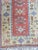 Pretty Turkish hallway rug, with geometric designs and pretty colors on a pink background, entirely hand-knotted, with...