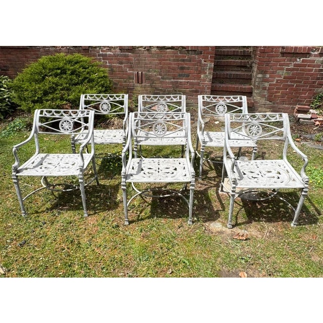 Set of 6 outdoor cast aluminum “Star and Dolphin” dining chairs. They have a gorgeous filigree patterned seat, star and...