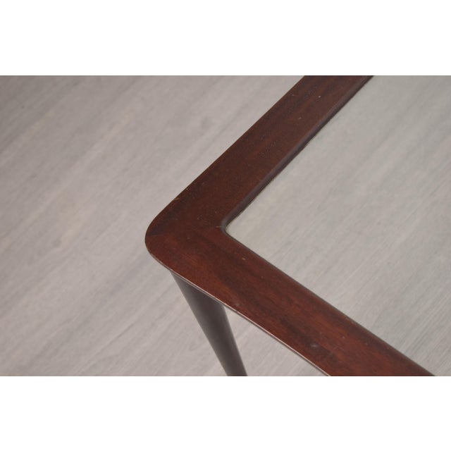 An elegant set of three nesting coffee tables, made in Italy in the 1950s. Crafted from solid wood with a recessed glass...