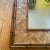 Listing is for a midcentury faux bamboo wall mirror. Plaited strips of rattan frame the mirror and hanging hardware is...