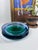 A striking, weighty art-glass bowl with a sculptural, stepped profile and beautifully layered color. Deep emerald green...