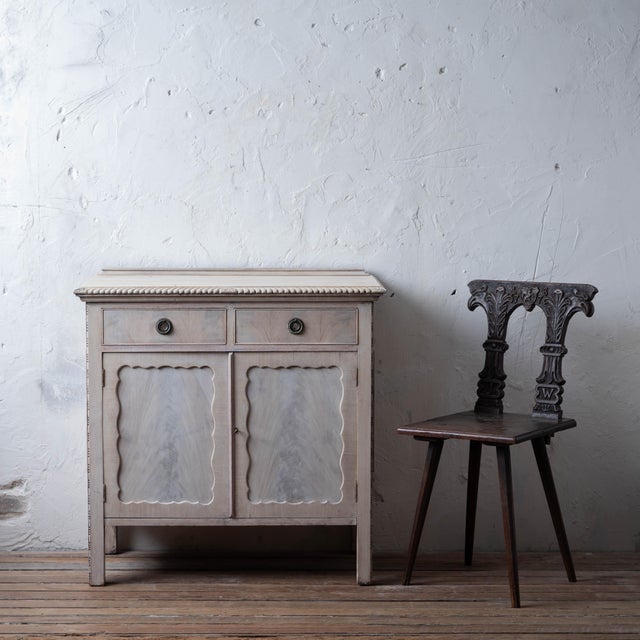An English bleached mahogany side cabinet, 19th century. Two drawers over two doors with internal shelf. 36 inches wide by...