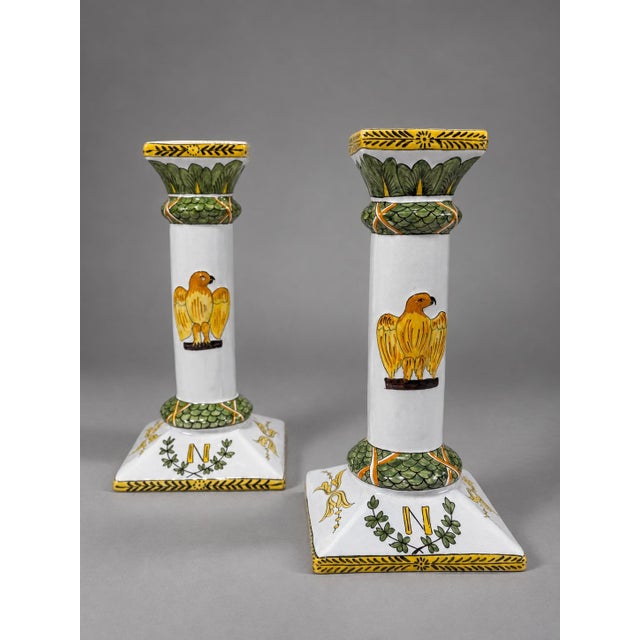 A decorative set of four French glazed faience candlesticks made for Lord & Taylor, mid-20th century, each formed as a...