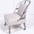A Restoration Hardware (RH) Couturier's chair, the exposed metal frame back over shaped linen upholstered seat, raised on...