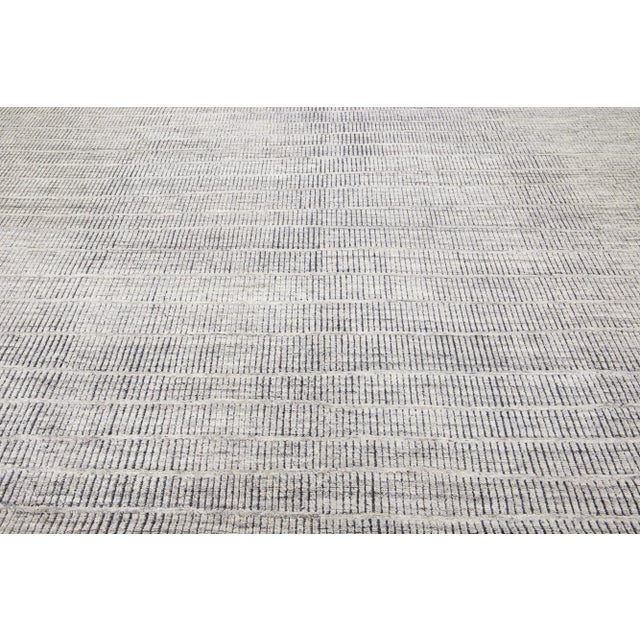 Beautiful modern Moroccan-style hand-knotted wool rug with a light gray color field. This rug is part of our Apadana's...
