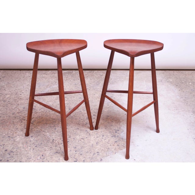 Pair of New Hope-Style walnut bar stools manufactured by David Scott in 1982. While Scott remains a noted name in...