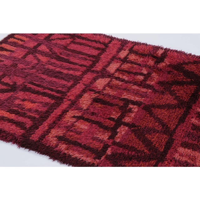 Hand-knotted in lush, high-pile wool in Sweden circa 1960-1970, this 4x6 vintage Swedish Rya rug is a bold new addition to...