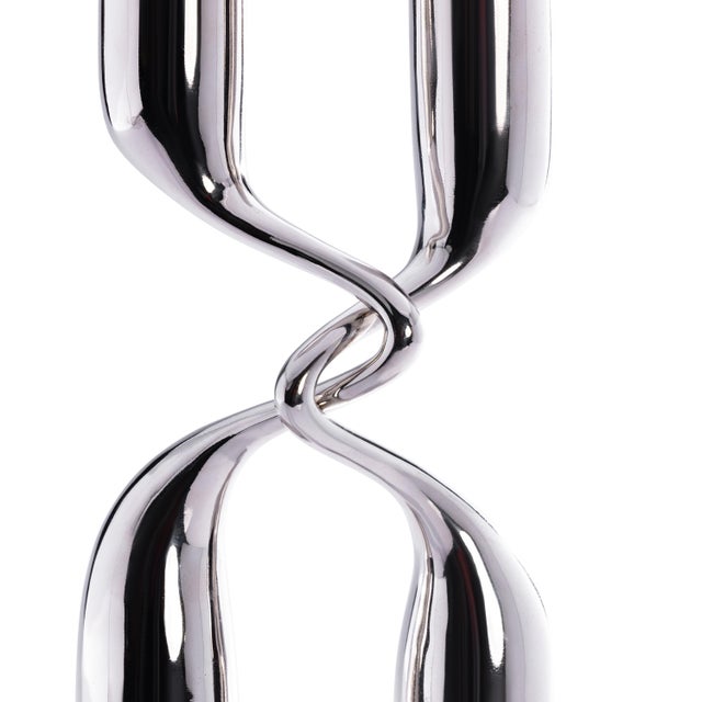 A statement of modern elegance, this 2-piece tapered candle holder set is crafted from aluminum with a polished nickel...