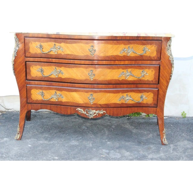 Charming French Louis XV style dresser commode chest featuring a shaped removable marble top above three large drawers...