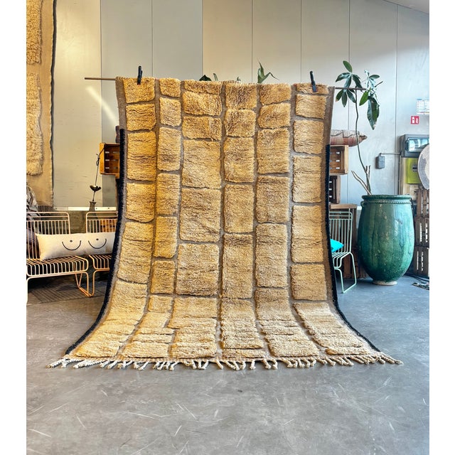 This Moroccan Beni Ouarain rug presents a refined interpretation of traditional Berber weaving, distinguished by its...