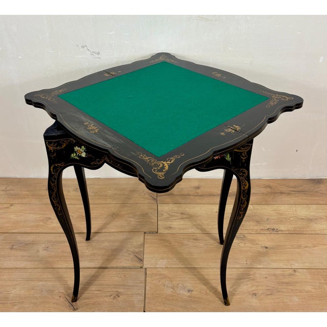 Elegant Chinese Chinoiserie games table in black lacquer, beautifully decorated with hand-painted floral motifs and...
